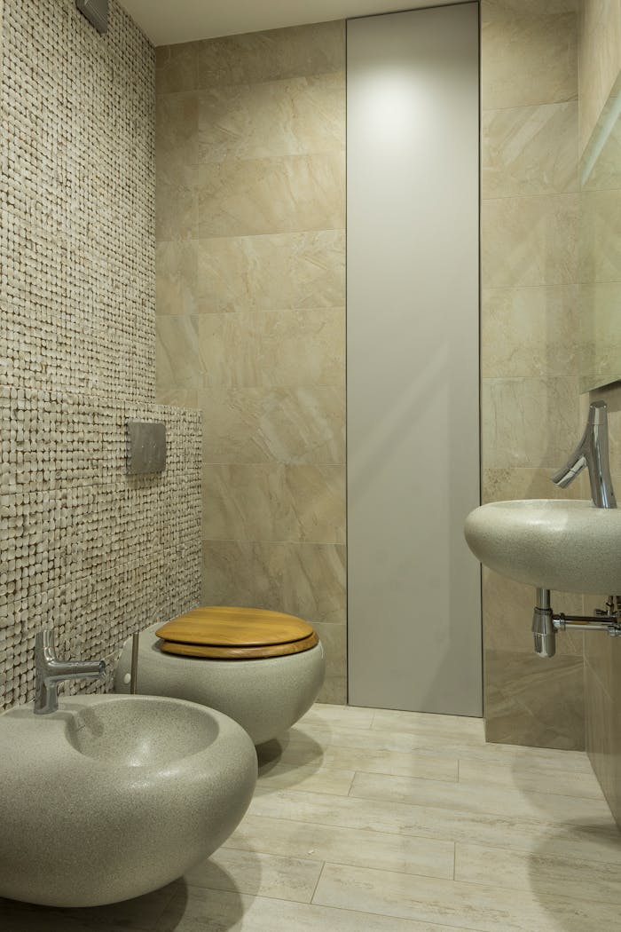 A contemporary bathroom featuring stone textures and modern fixtures.